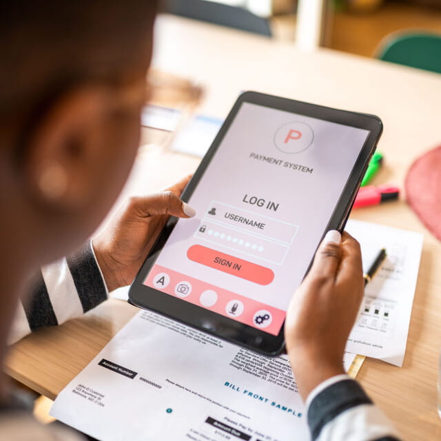 A person using a tablet with a login on the screen